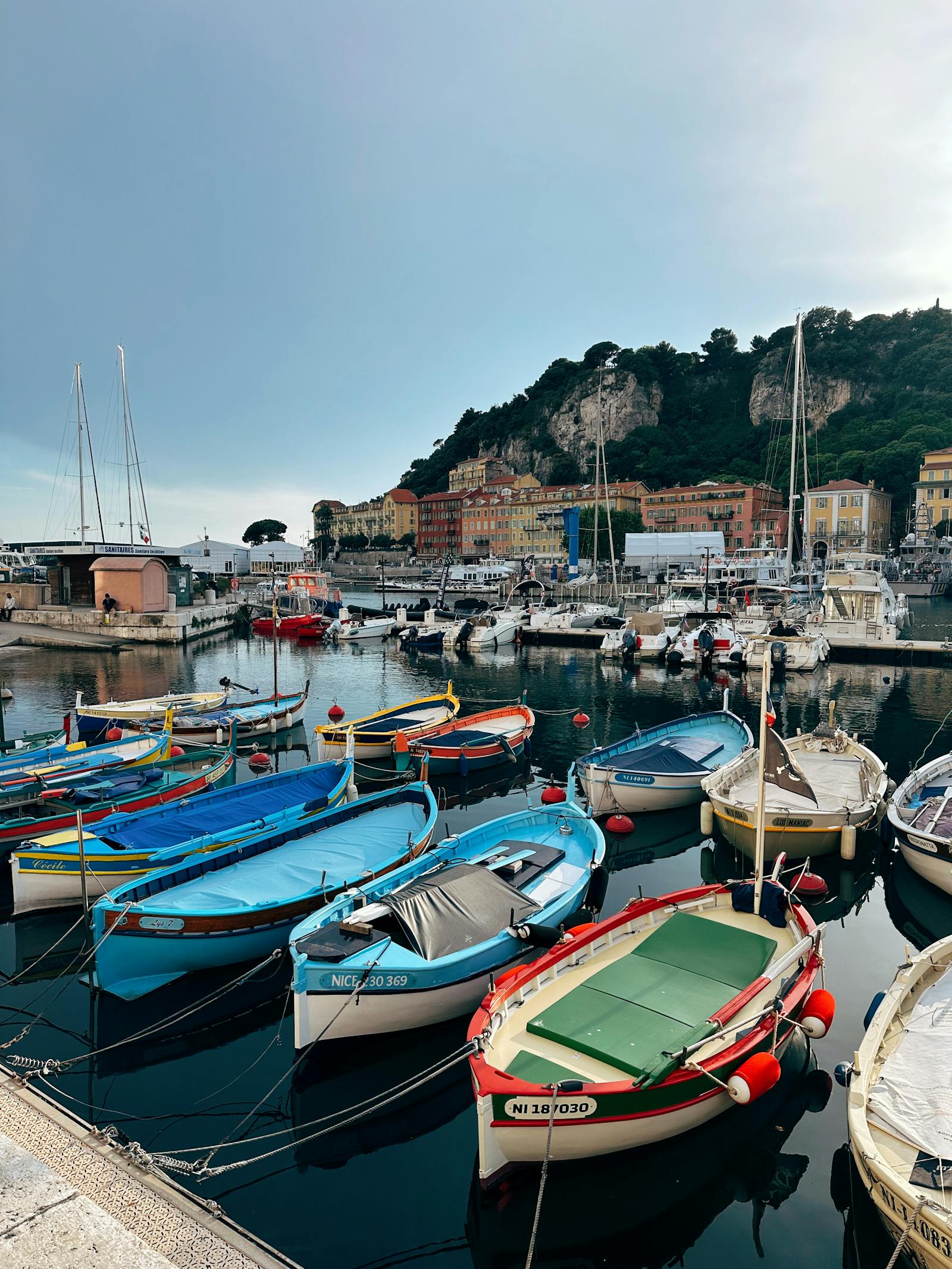 Yachts moored along the French Riviera coast at sunset