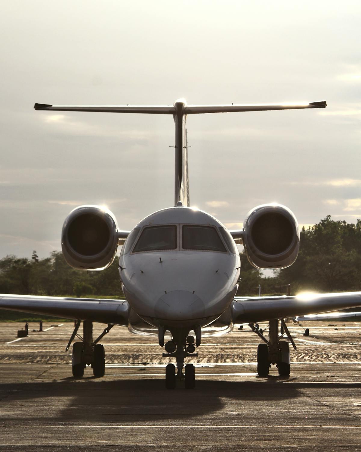 Small jet aircraft on a runway at sunset