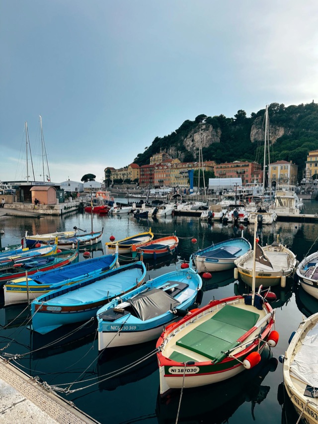 Yachts moored along the French Riviera coast at sunset