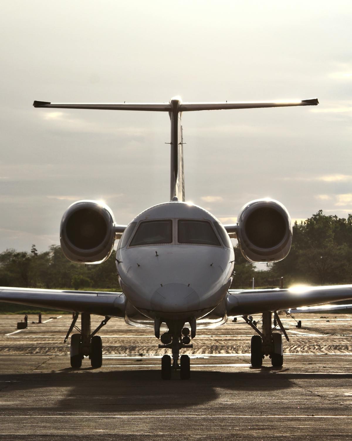A light jet on the runway at a UK airfield in early morning light