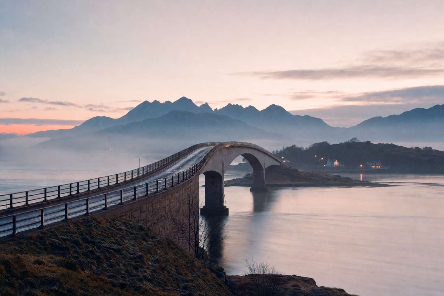 The Skye Bridge at Kyle of Lochalsh in early morning mist, with the Cuillin hills faint on the horizon