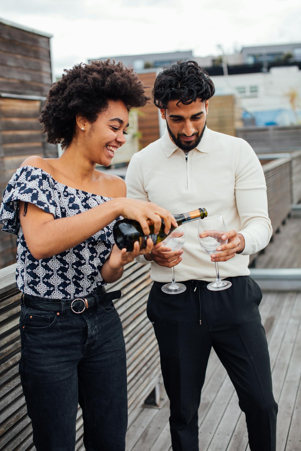 Couple celebrating with champagne on a terrace