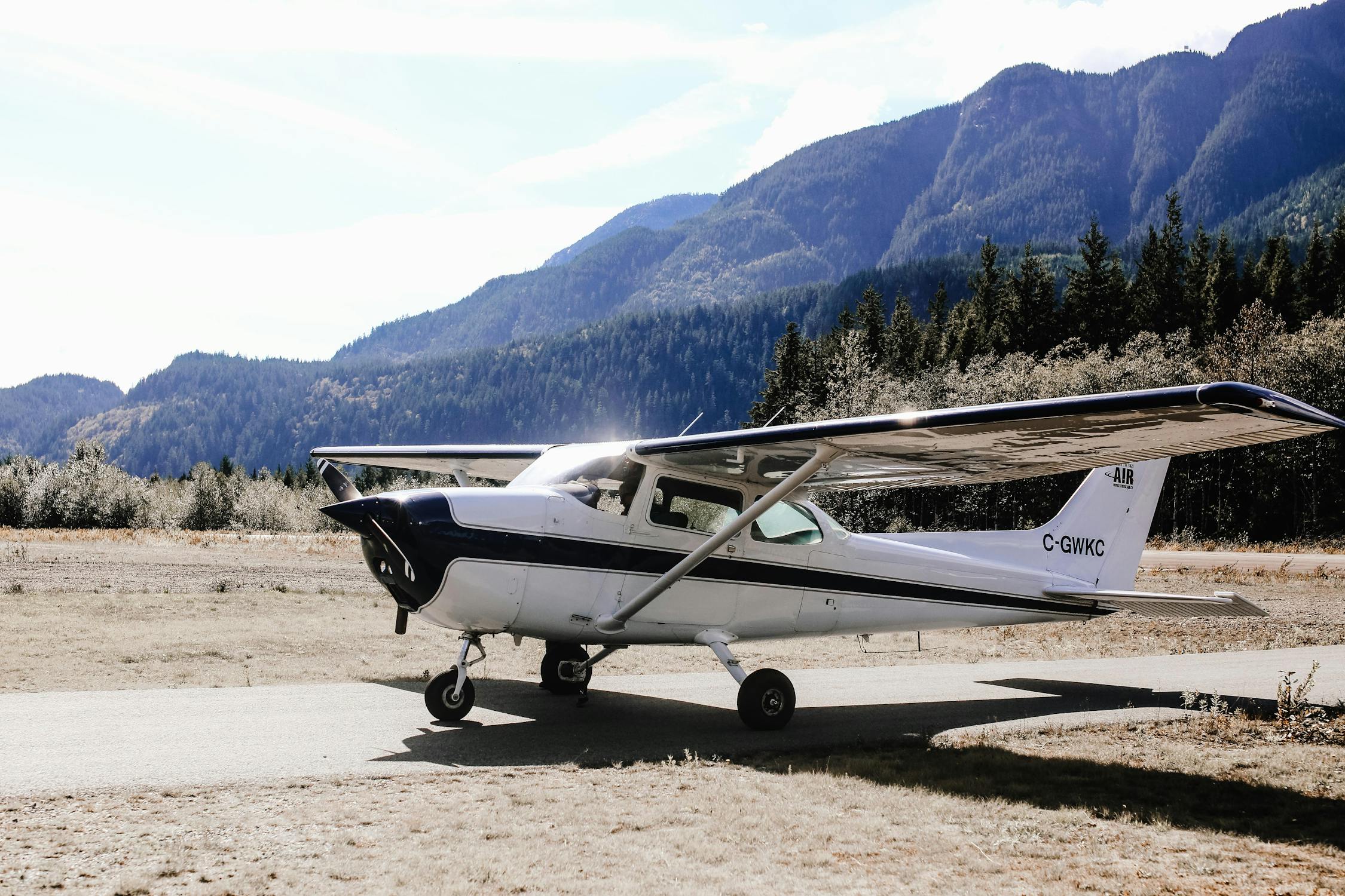 Small aircraft on a UK grass airstrip with a pilot preparing for flight