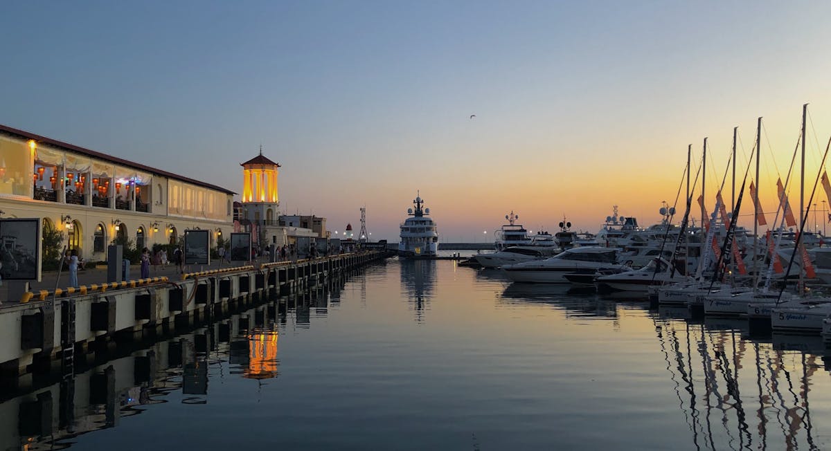 Sunset over a yacht marina with boats at dock